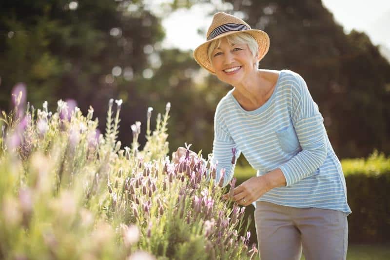woman with allergy treatment enjoying garden